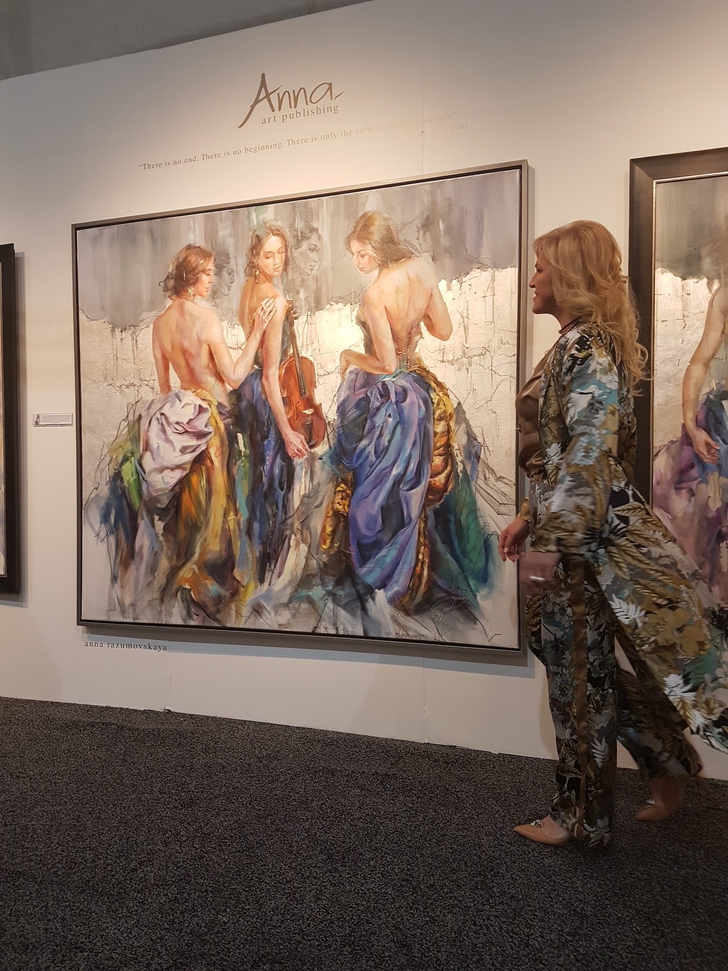 Anna beside a large silver-leaf figurative painting