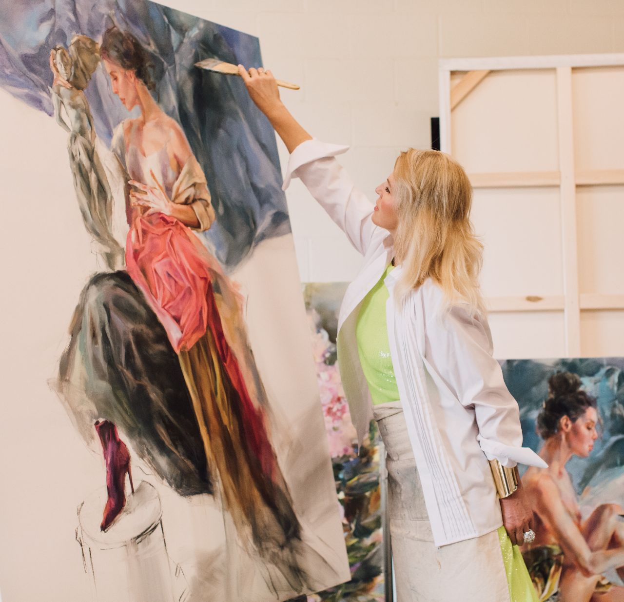 Close view of Anna Razumovskaya raising a broad brush to the canvas